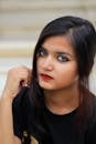 Striking portrait of a young woman with captivating eyes and red lips. Perfect for fashion and makeup themes.